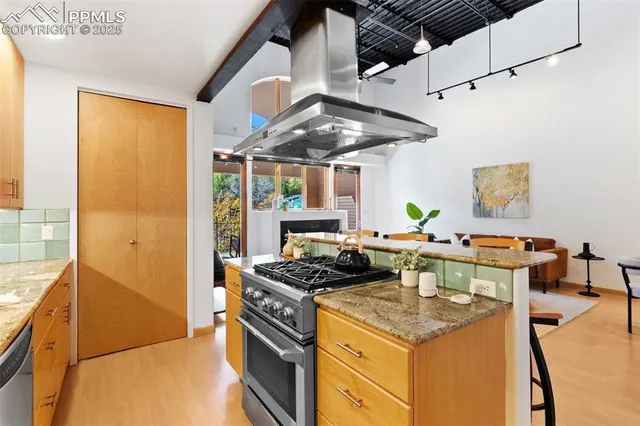 a kitchen with stainless steel appliances granite countertop a stove and a refrigerator