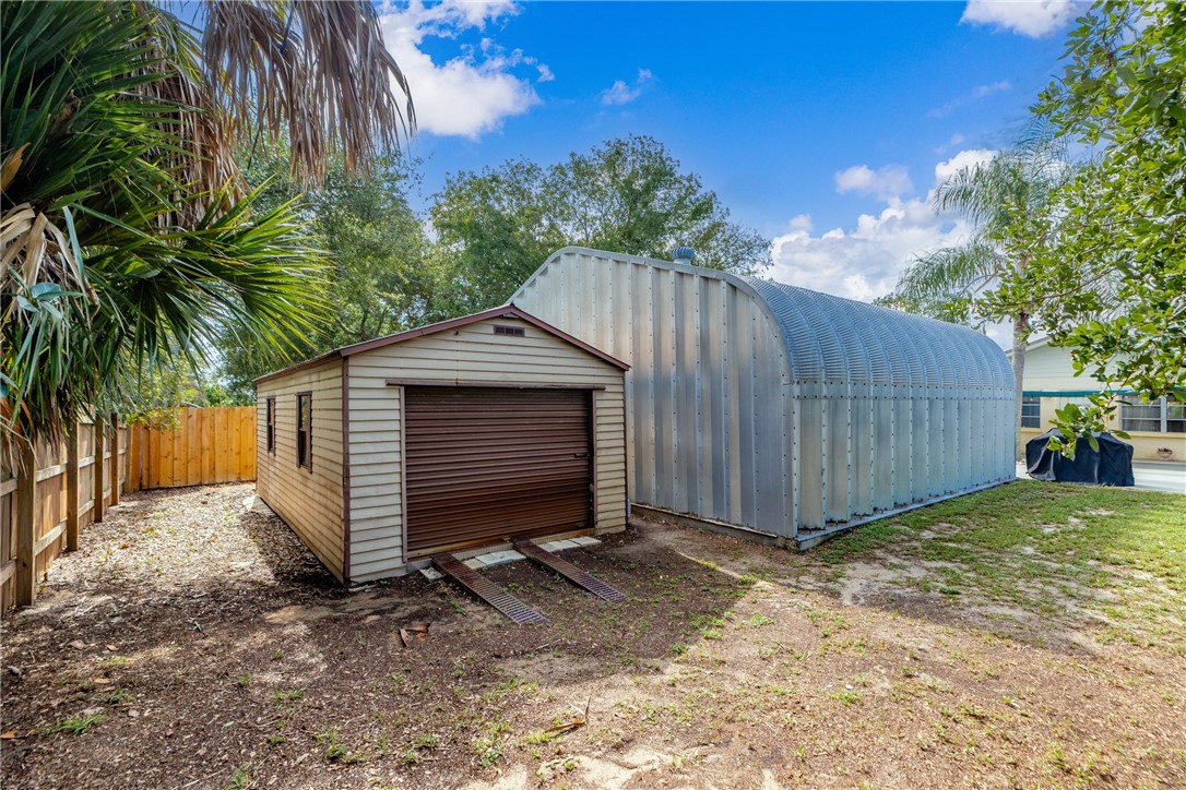 7666 134th Street Sebastian, FL 32958 - Photo 31 of 35 a view of backyard with potted plants and a large tree