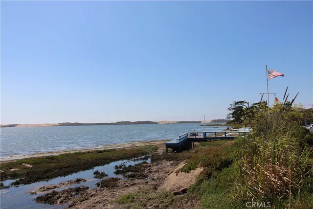 a front view of a building with streets and trees