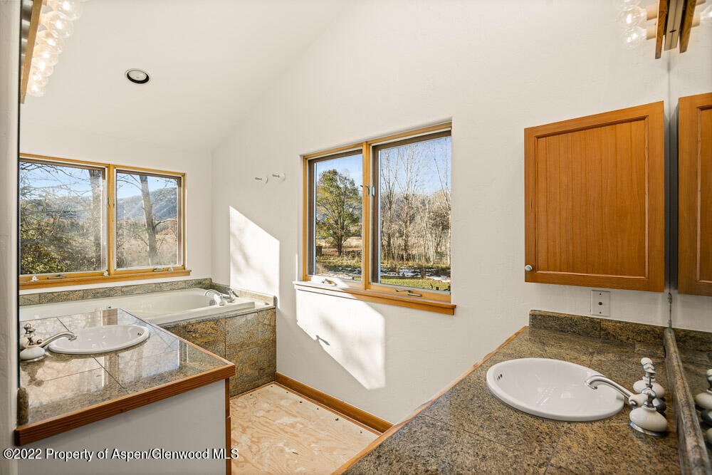 98 Lewis Lane Basalt, CO 81621 - Photo 14 of 31 a bathroom with a granite countertop sink and mirror with bathtub