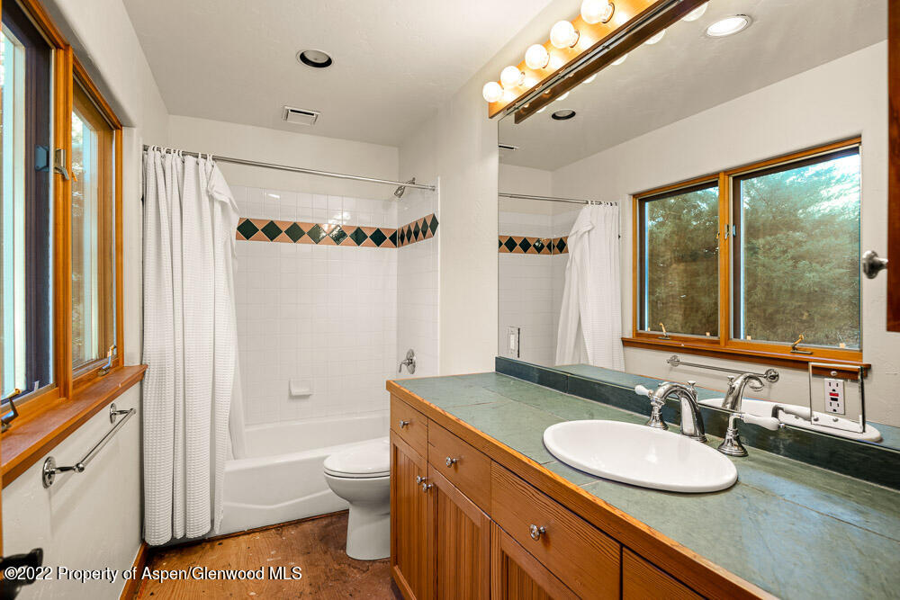 98 Lewis Lane Basalt, CO 81621 - Photo 19 of 31 a bathroom with a granite countertop sink mirror vanity and a bathtub