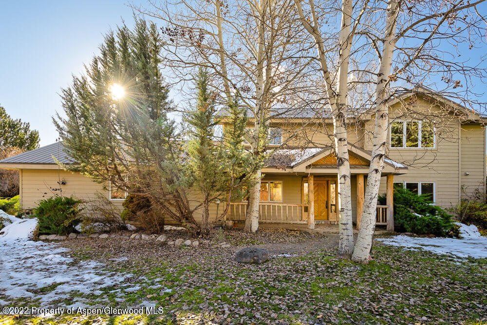 98 Lewis Lane Basalt, CO 81621 - Photo 2 of 31 a front view of a house with a yard and garage