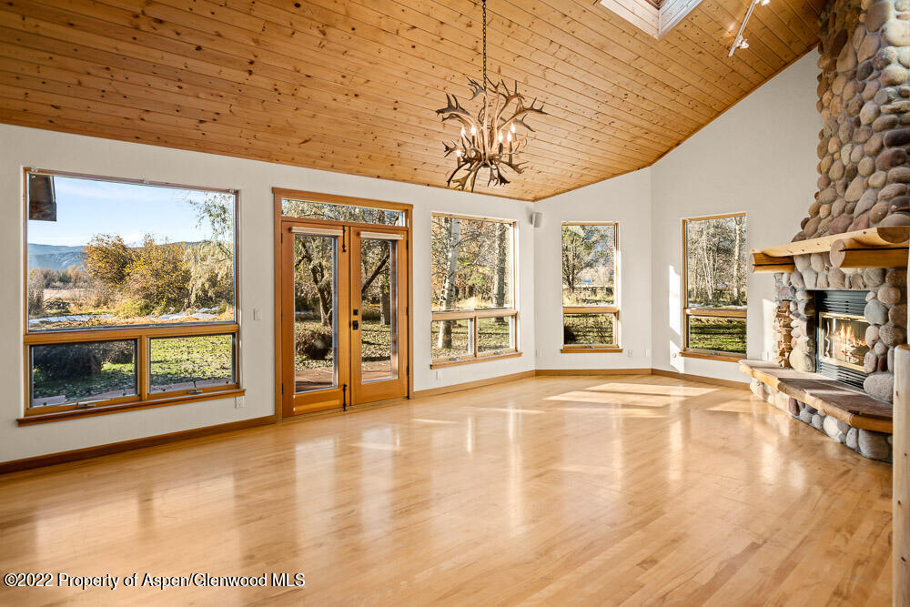 98 Lewis Lane Basalt, CO 81621 - Photo 3 of 31 a view of an empty room with a window and wooden floor