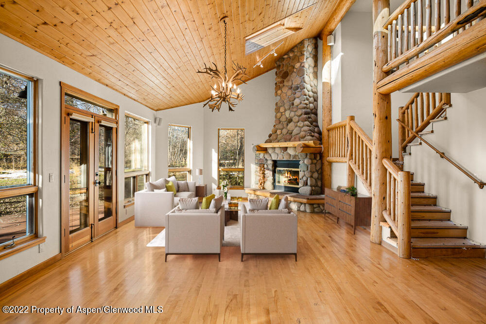 98 Lewis Lane Basalt, CO 81621 - Photo 6 of 31 a living room with fireplace furniture and a wooden floor