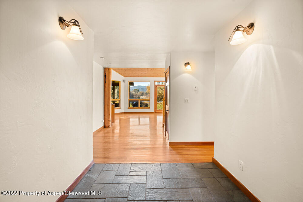 98 Lewis Lane Basalt, CO 81621 - Photo 7 of 31 a view of a hallway with wooden floor and a bathroom
