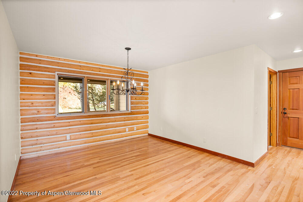 98 Lewis Lane Basalt, CO 81621 - Photo 8 of 31 a view of an empty room with wooden floor and a window