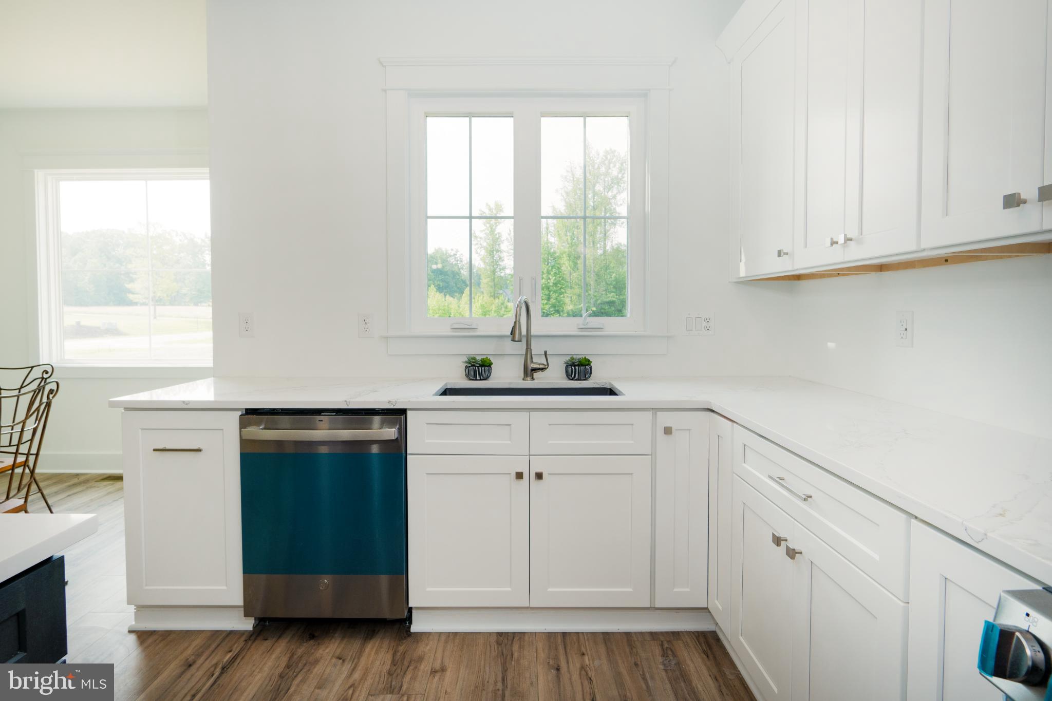 723 Rainbow Ridge Bumpass, VA 23024 - Photo 15 of 60 a kitchen with white cabinets and a window