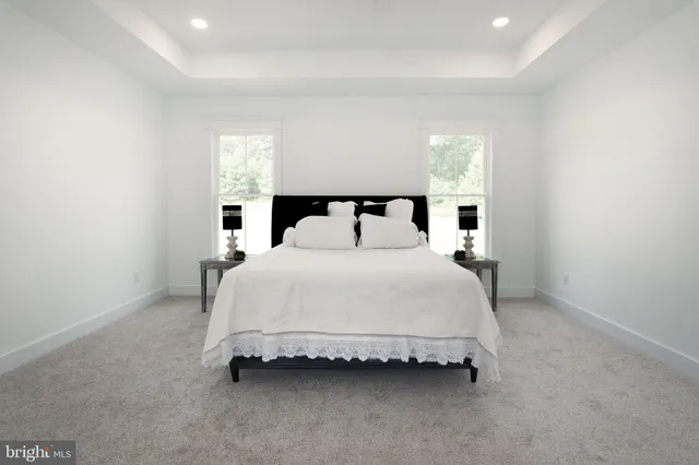 a bathroom with a granite countertop sink a toilet and a mirror