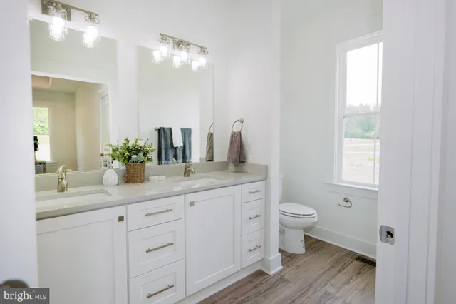 a bathroom with a shower sink and mirror