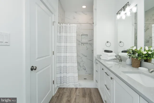 a bathroom with a sink a mirror and a shower