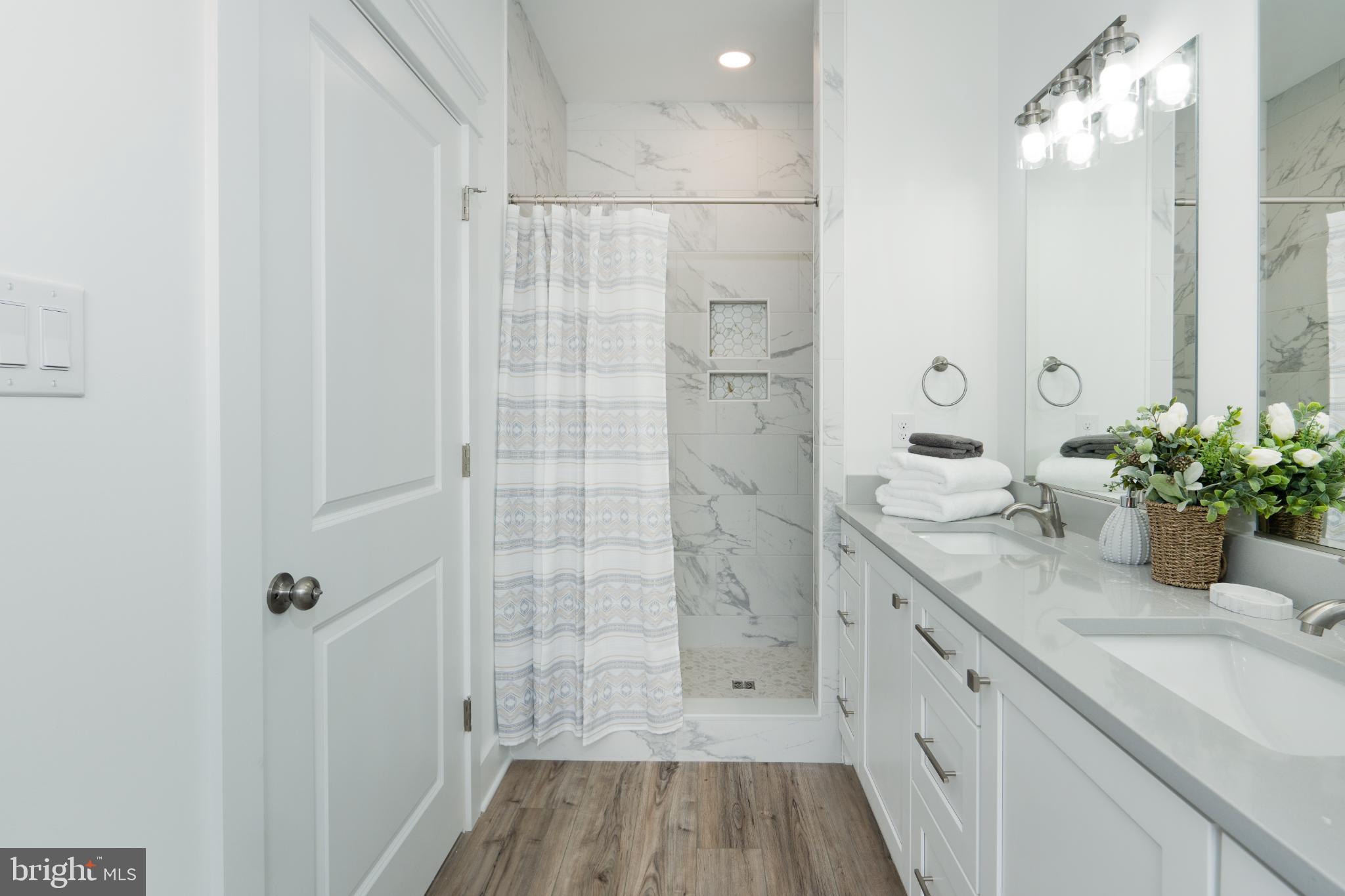 723 Rainbow Ridge Bumpass, VA 23024 - Photo 25 of 60 a bathroom with a shower sink and mirror