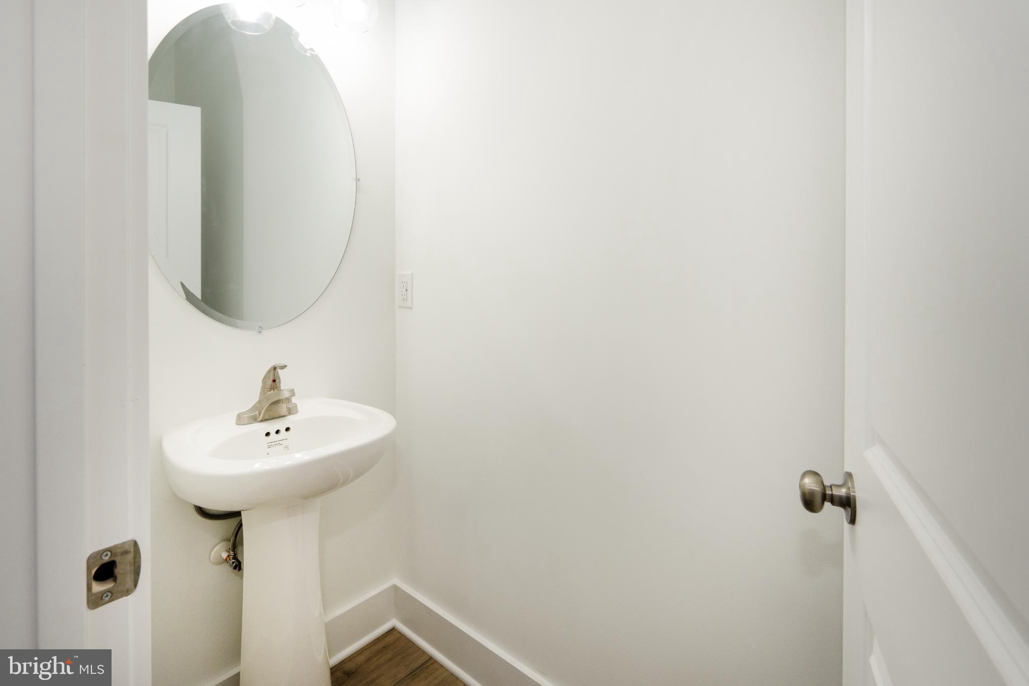 723 Rainbow Ridge Bumpass, VA 23024 - Photo 27 of 60 a bathroom with a sink a mirror and a shower