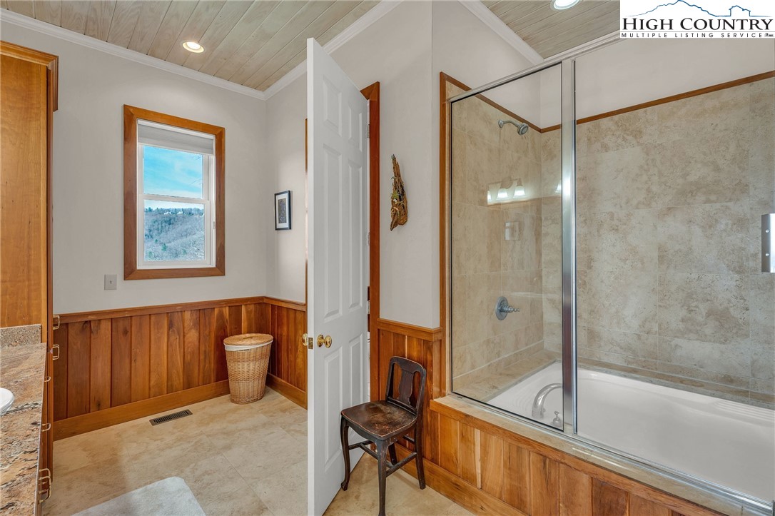 933 Thunder Ridge Lane Lenoir, NC 28645 - Photo 23 of 45 a bathroom with a tub and a shower