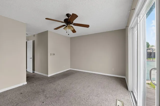 a view of room with a ceiling fan and window