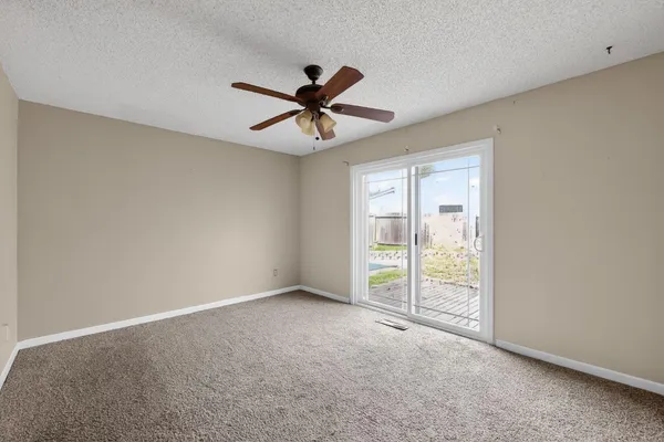 a view of a livingroom with a ceiling fan and window