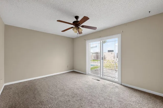a view of a livingroom with a ceiling fan and window