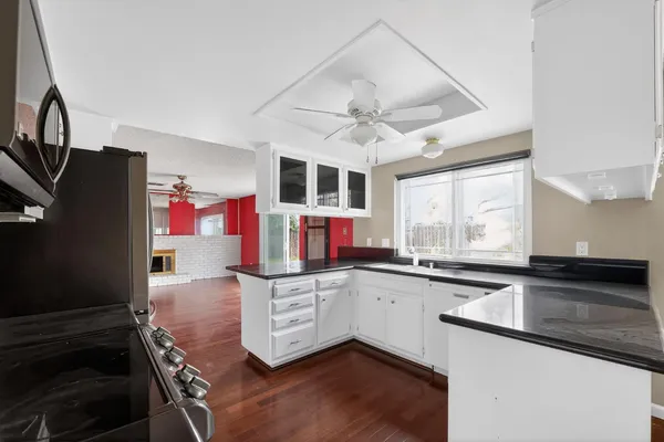 a kitchen with stainless steel appliances a sink stove and cabinets