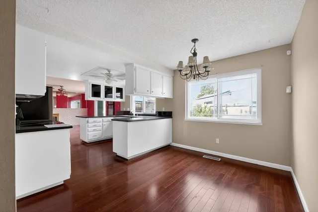a living room with kitchen island furniture and a flat screen tv