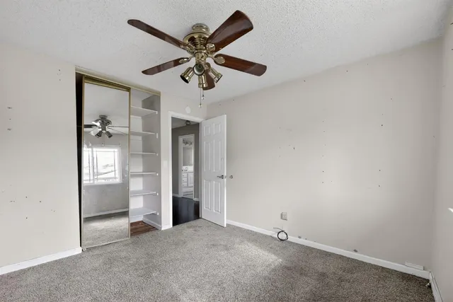 an empty room with a empty space and a ceiling fan