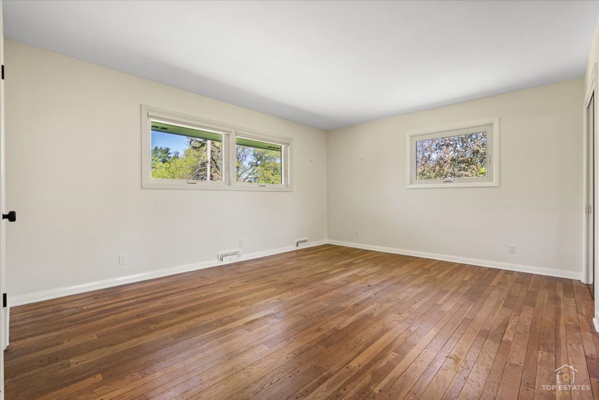 326 Charles Street Geneva, IL 60134 - Photo 15 of 33 a view of an empty room with wooden floor and window
