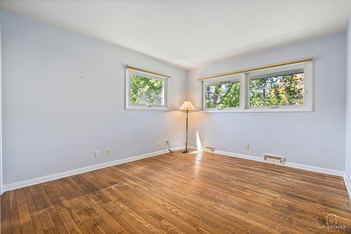 326 Charles Street Geneva, IL 60134 - Photo 19 of 33 a view of an empty room with wooden floor and a window