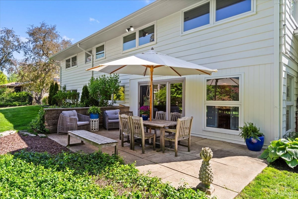 326 Charles Street Geneva, IL 60134 - Photo 27 of 33 a view of a patio with table and chairs under an umbrella