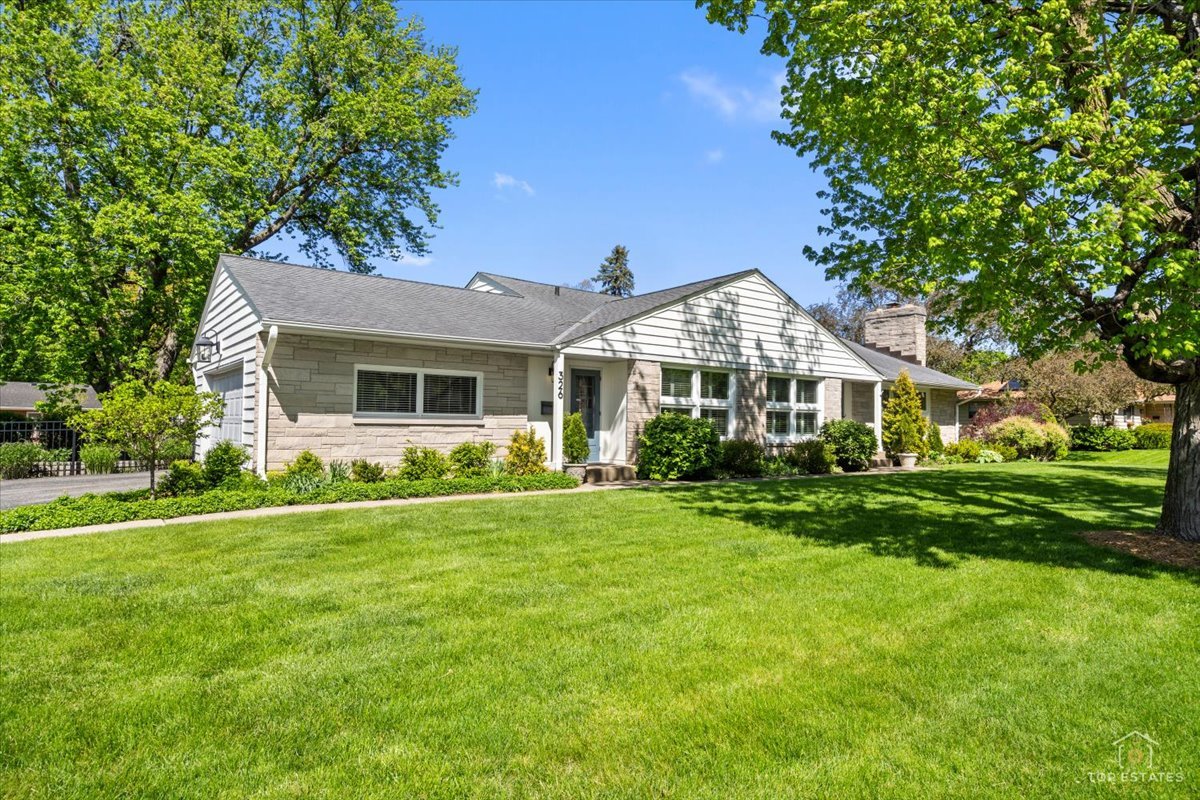 326 Charles Street Geneva, IL 60134 - Photo 4 of 33 a front view of a house with a garden