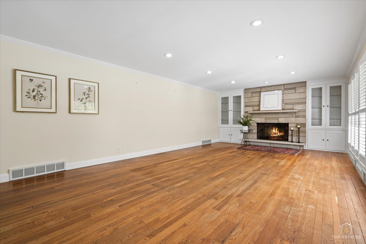 326 Charles Street Geneva, IL 60134 - Photo 5 of 33 a view of empty room with wooden floor and fireplace