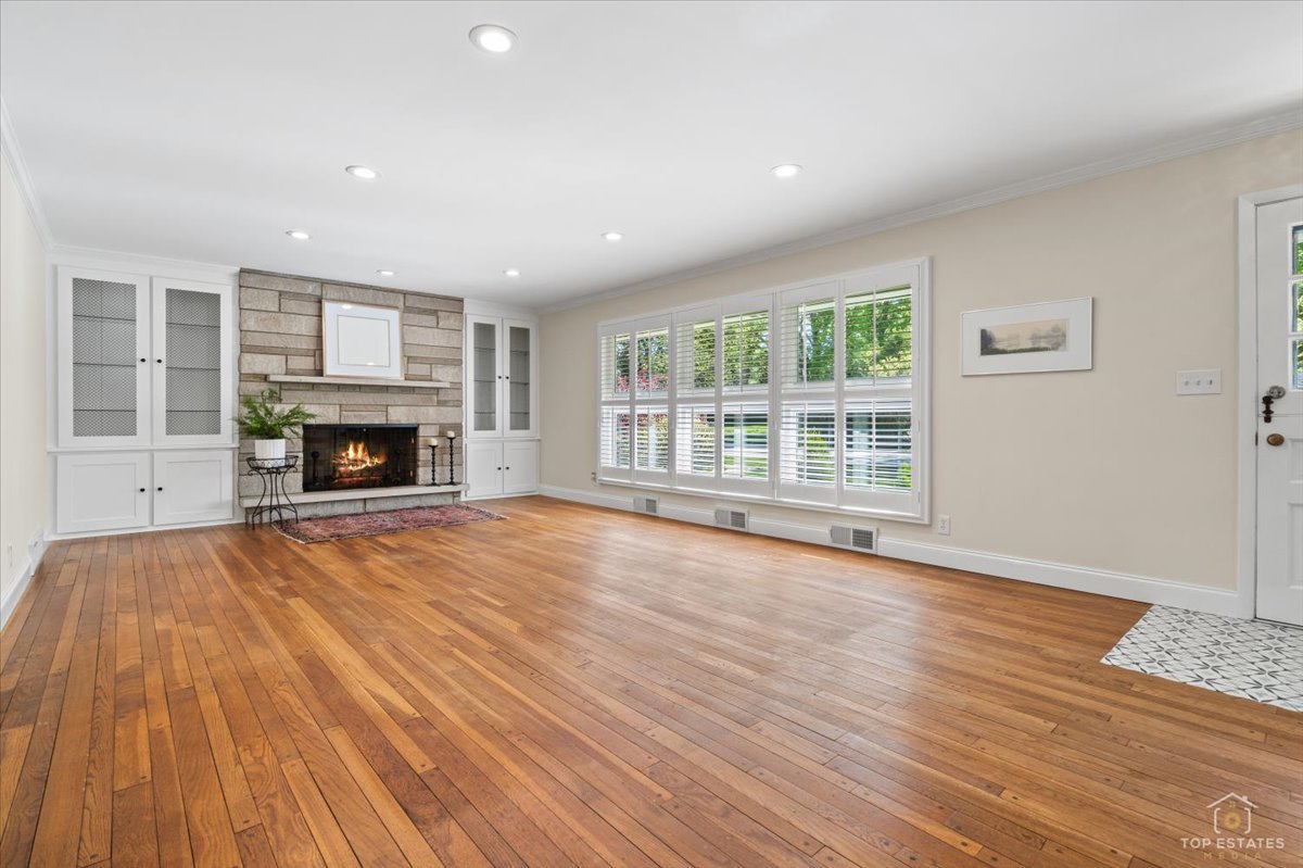 326 Charles Street Geneva, IL 60134 - Photo 6 of 33 an empty room with wooden floor fireplace and windows