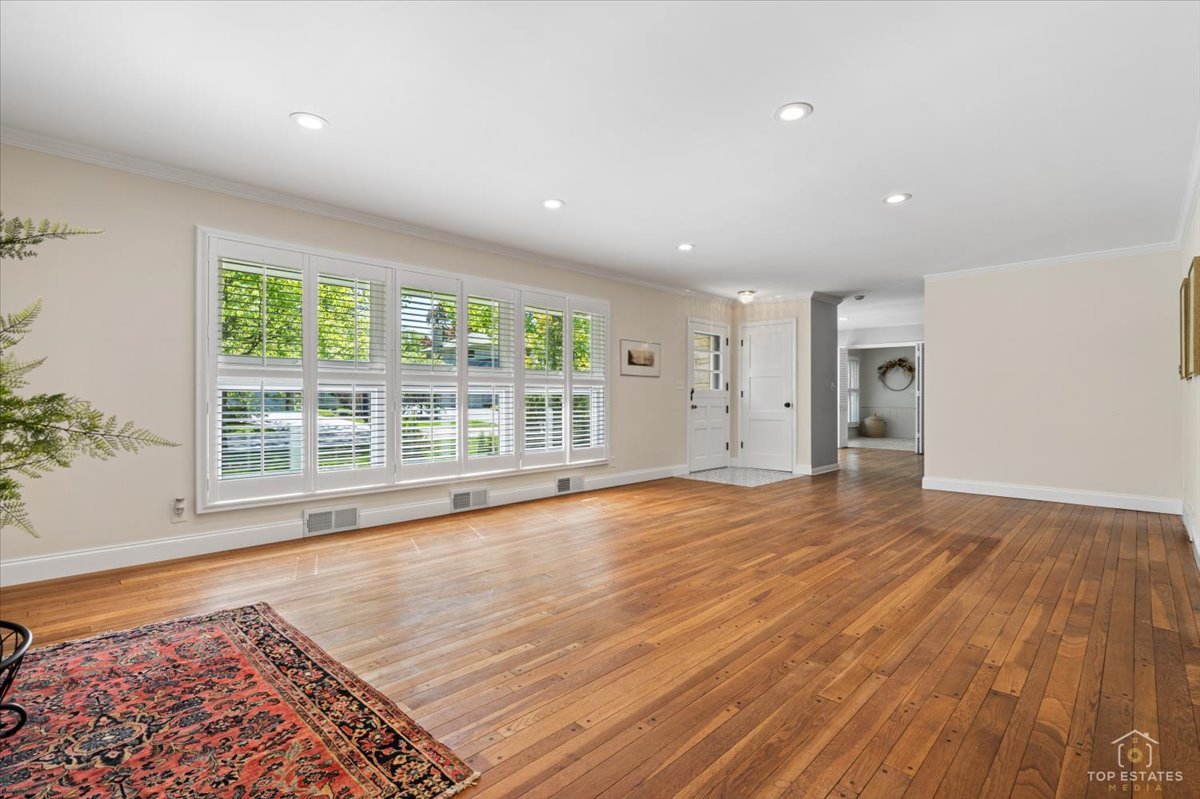 326 Charles Street Geneva, IL 60134 - Photo 7 of 33 a view of an empty room with wooden floor and a window