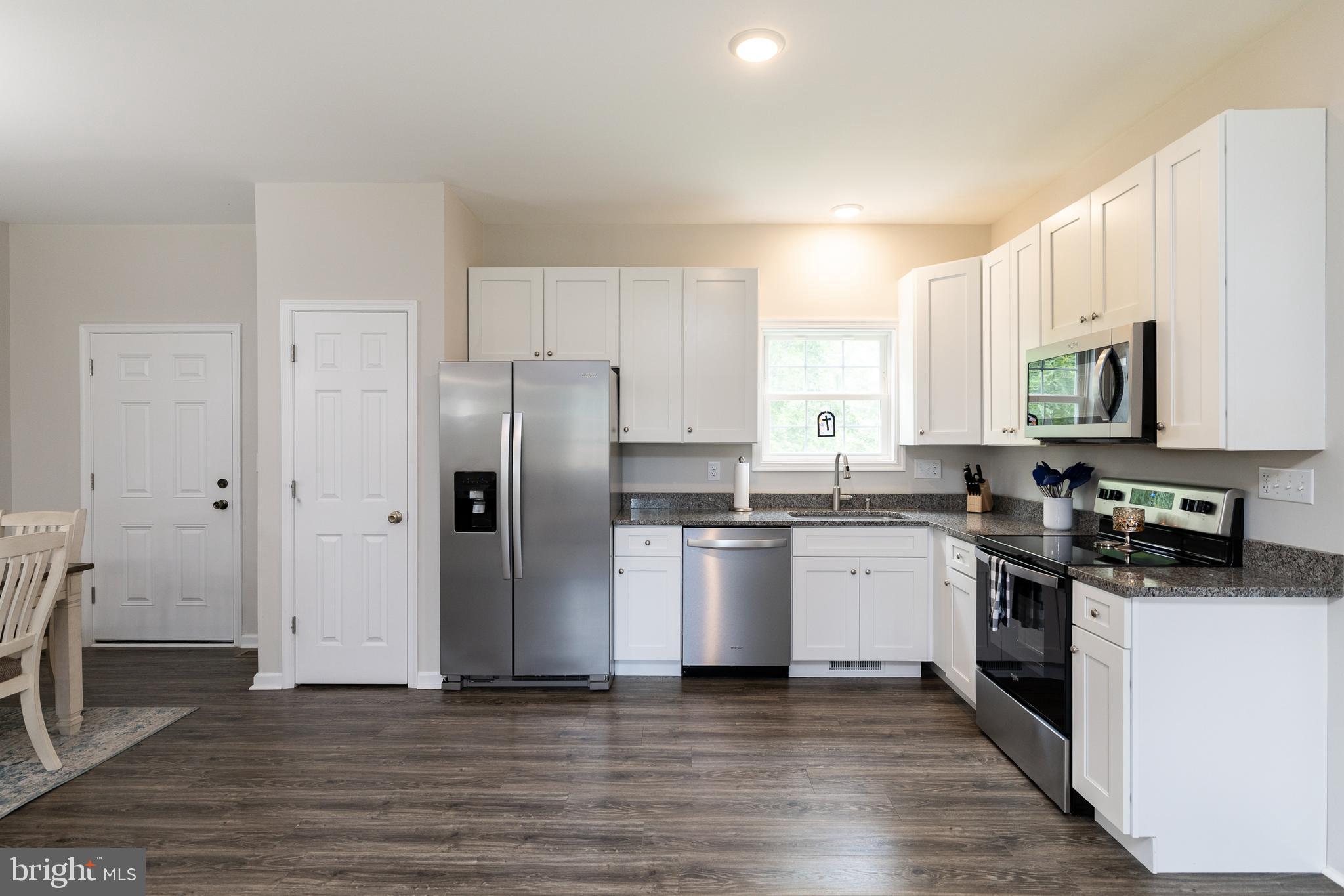 33 Sinker Drive Inwood, WV 25428 - Photo 11 of 31 a kitchen with stainless steel appliances a refrigerator stove and sink