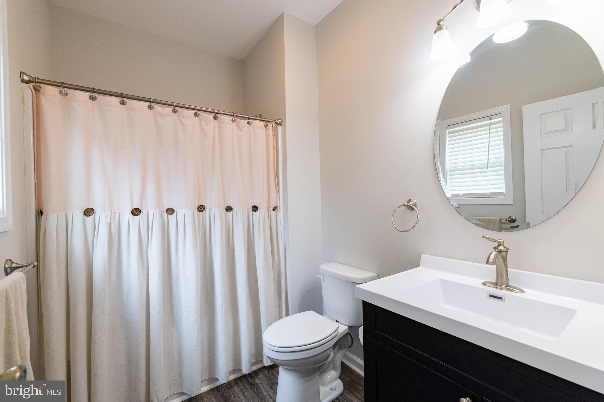 33 Sinker Drive Inwood, WV 25428 - Photo 16 of 31 a bathroom with a granite countertop toilet a sink and a mirror