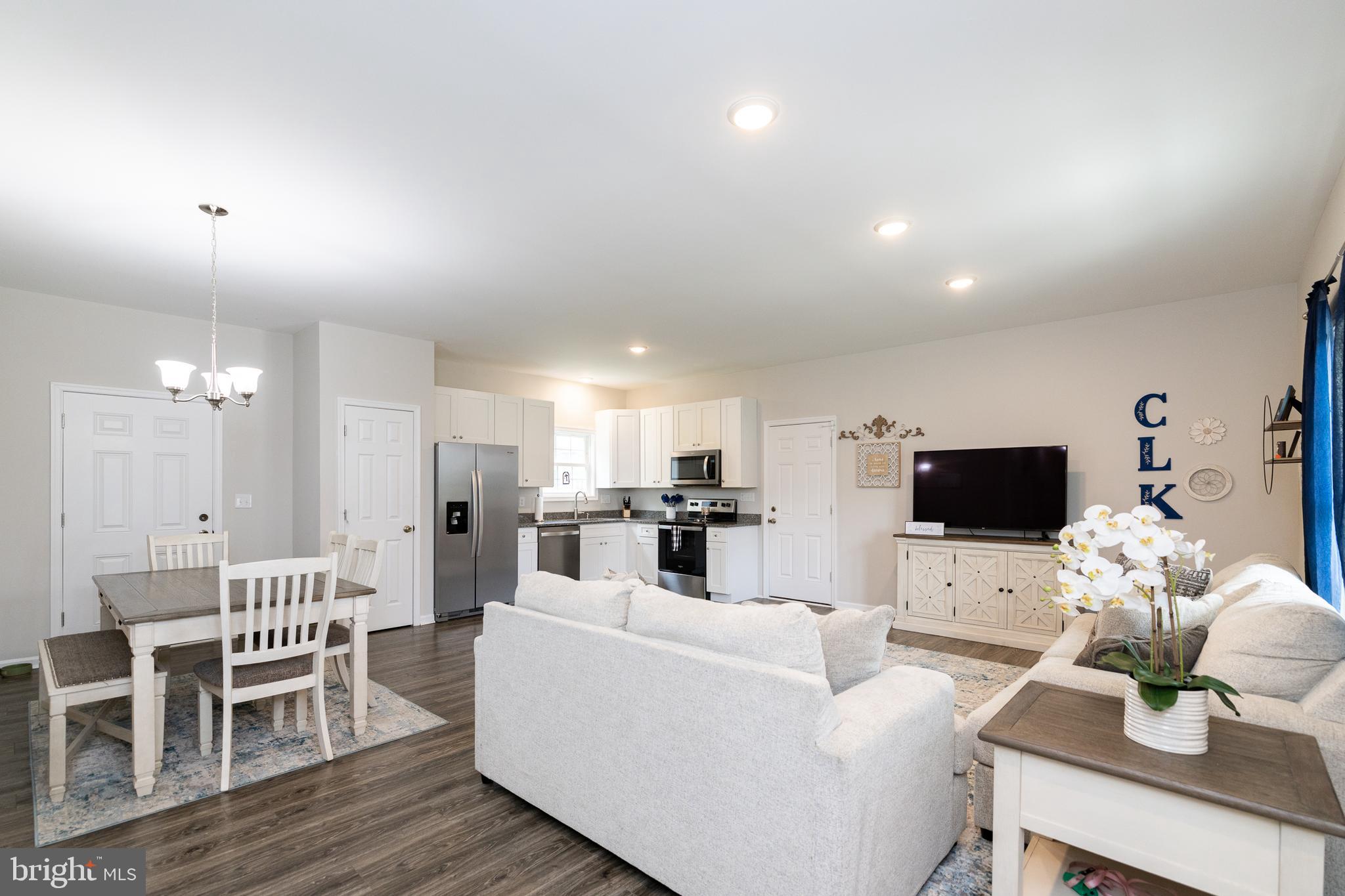 33 Sinker Drive Inwood, WV 25428 - Photo 8 of 31 a living room with furniture a fireplace and a flat screen tv