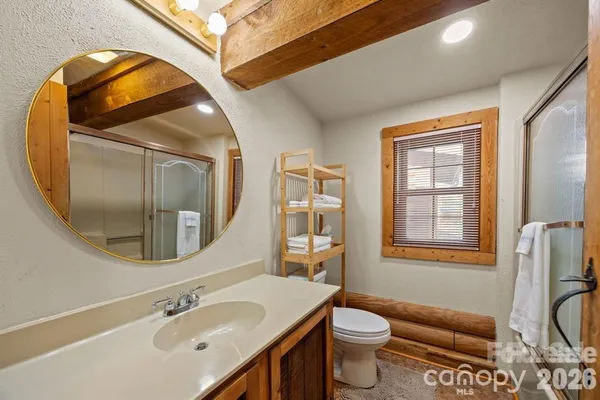 a bathroom with a sink a toilet a mirror and a tub