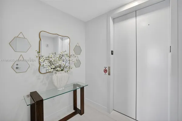 a living room with furniture a flat screen tv and a large window