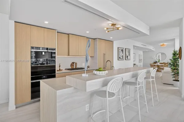 a dining room with furniture a potted plant and a mirror