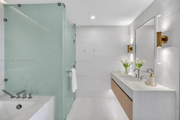 a view of a balcony with floor to ceiling windows and wooden fence