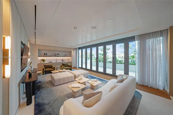 a living room with furniture fireplace and a large window