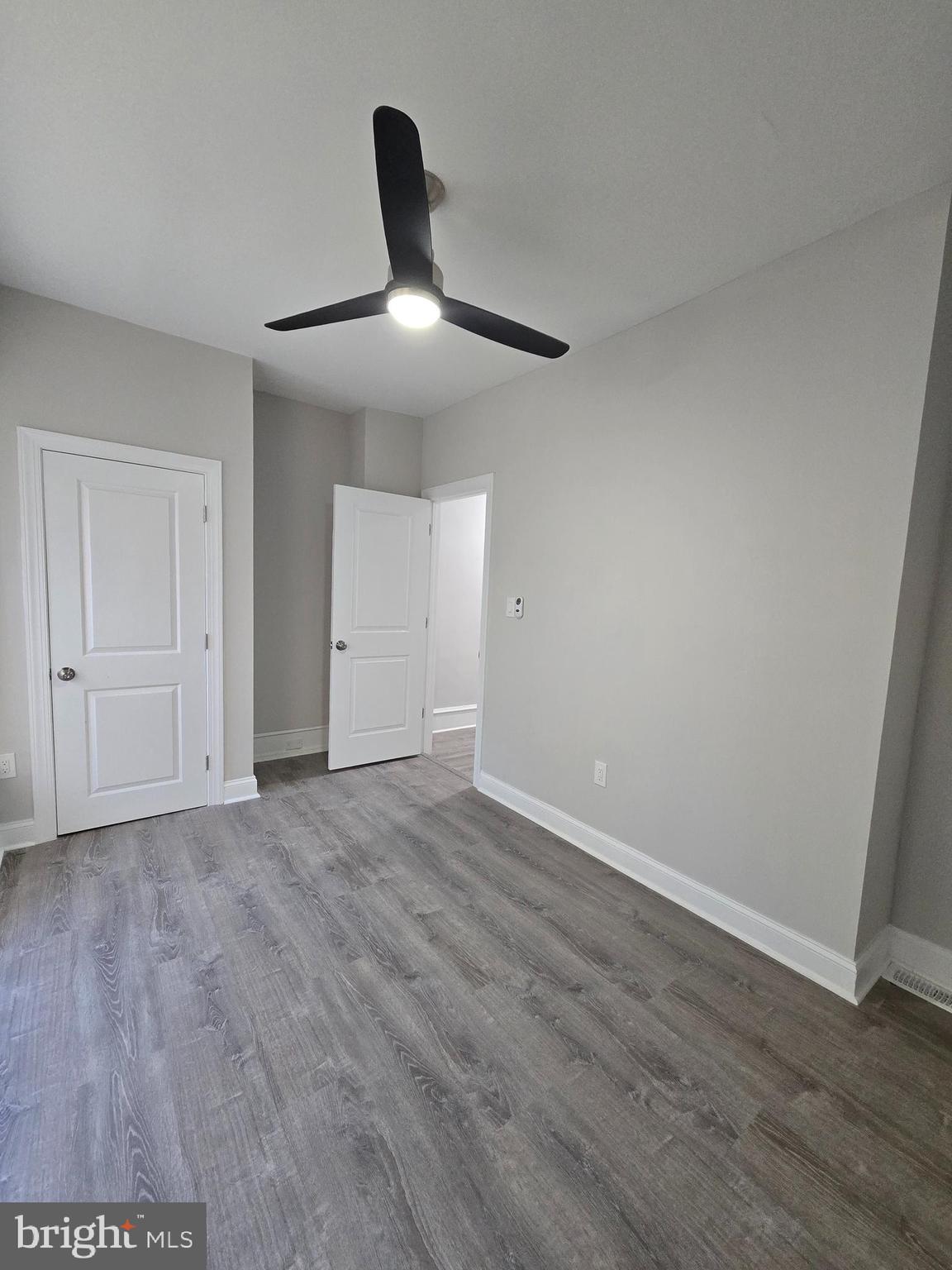 5211 Ridge Avenue, Unit 2 Philadelphia, PA 19128 - Photo 13 of 23 a view of an empty room with wooden floor and a ceiling fan