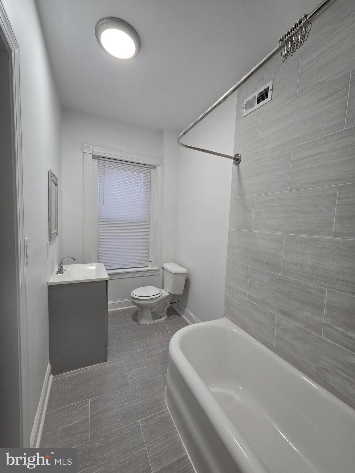 5211 Ridge Avenue, Unit 2 Philadelphia, PA 19128 - Photo 15 of 23 a bathroom with a sink a toilet and shower