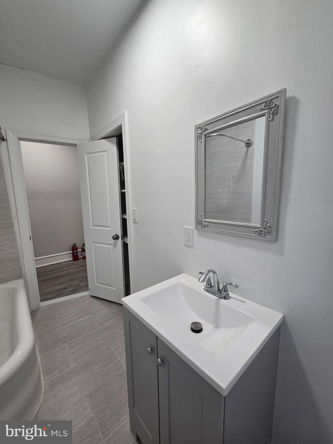 5211 Ridge Avenue, Unit 2 Philadelphia, PA 19128 - Photo 16 of 23 a bathroom with a sink mirror and a toilet