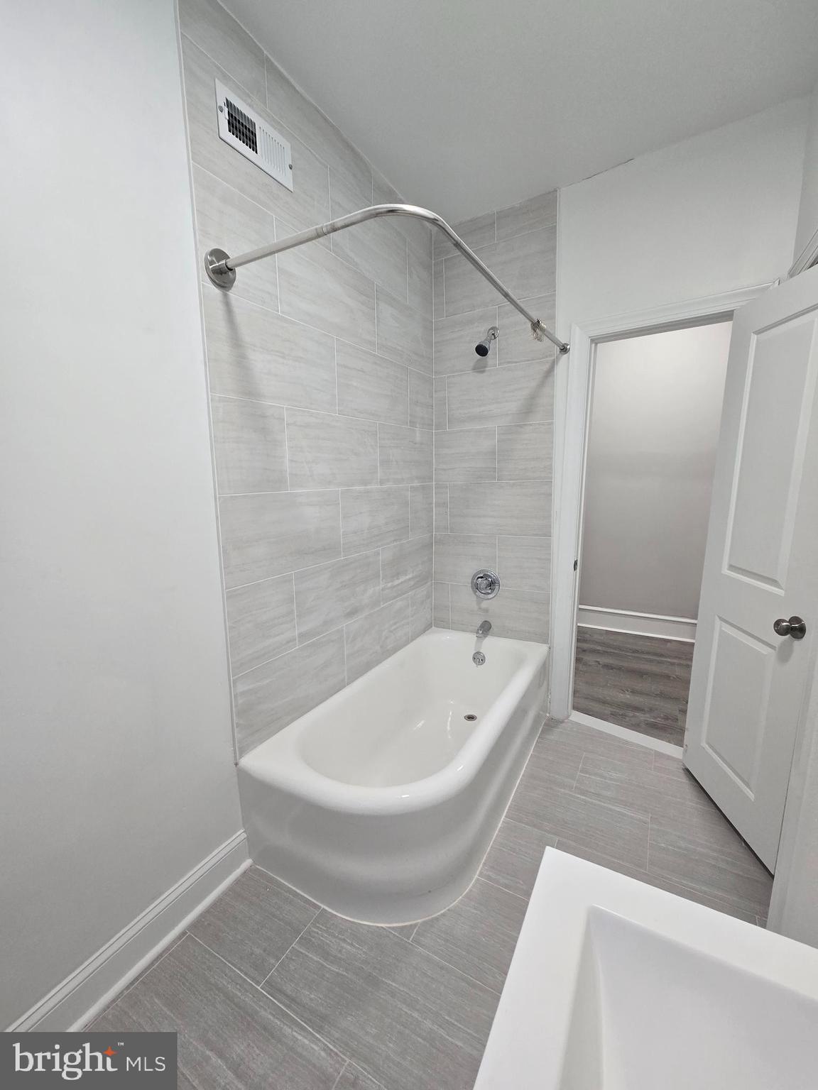 5211 Ridge Avenue, Unit 2 Philadelphia, PA 19128 - Photo 20 of 23 a white bath tub sitting next to a white toilet