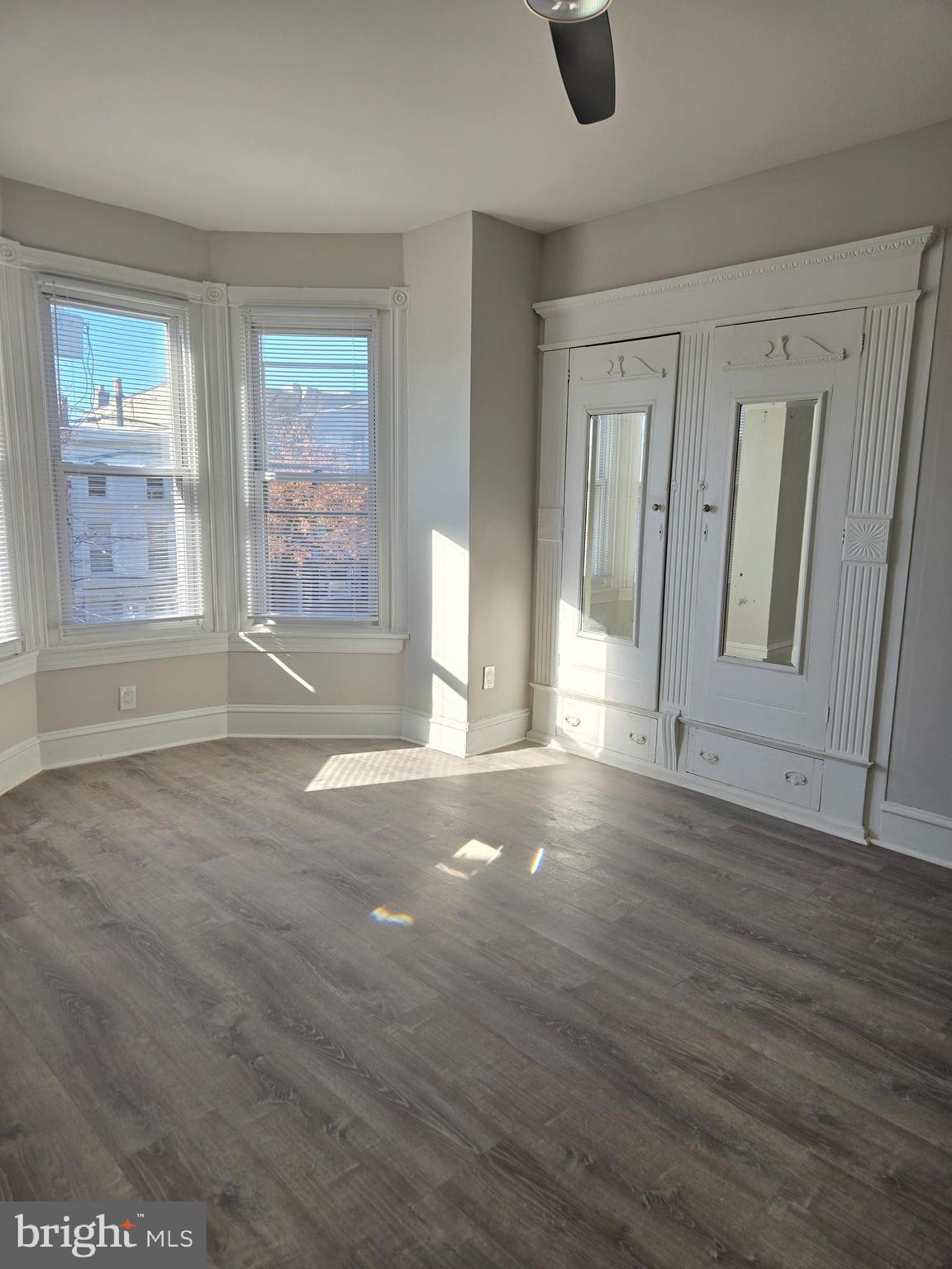 5211 Ridge Avenue, Unit 2 Philadelphia, PA 19128 - Photo 7 of 23 an empty room with wooden floor and windows