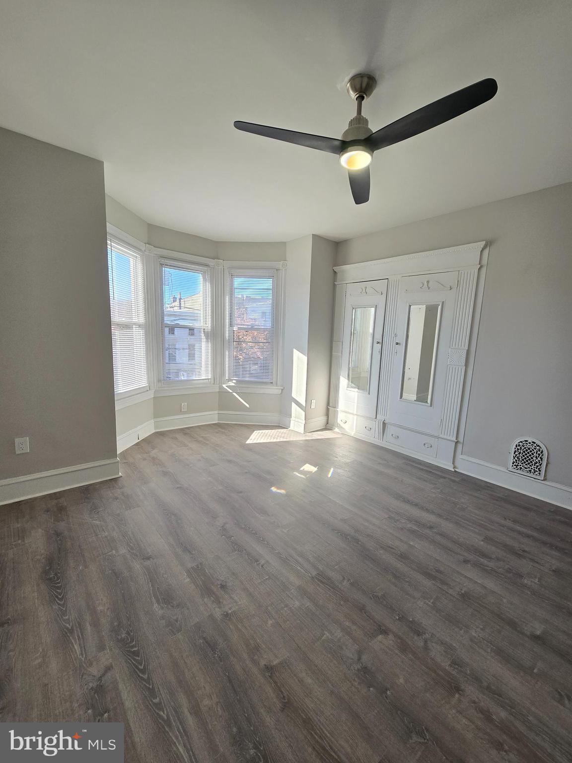 5211 Ridge Avenue, Unit 2 Philadelphia, PA 19128 - Photo 8 of 23 a view of an empty room with window and wooden floor