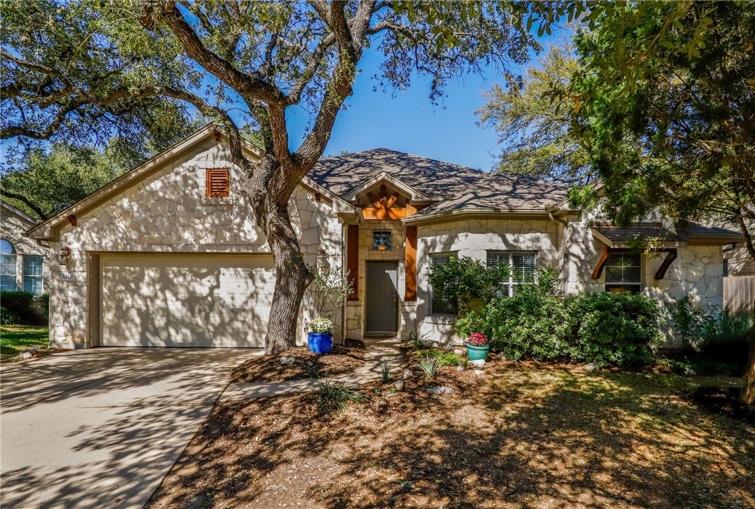 a view of a house with a tree in front