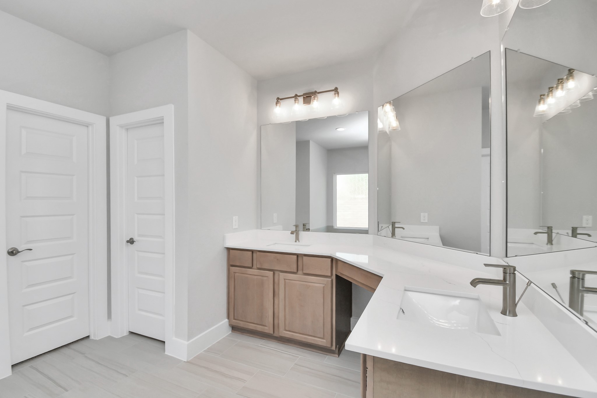 3031 Native Spg Drive Spring, TX 77373 - Photo 18 of 30 Escape to a spa-like oasis in this primary bathroom. Enjoy a walk-in shower with tile surround, a separate garden tub with custom detailing, and an elegant vanity featuring light countertops, modern hardware, and beautiful vanity lights. Experience luxury and relaxation in every detail. Sample photo of completed home with similar floor plan. Actual colors and selections may vary.