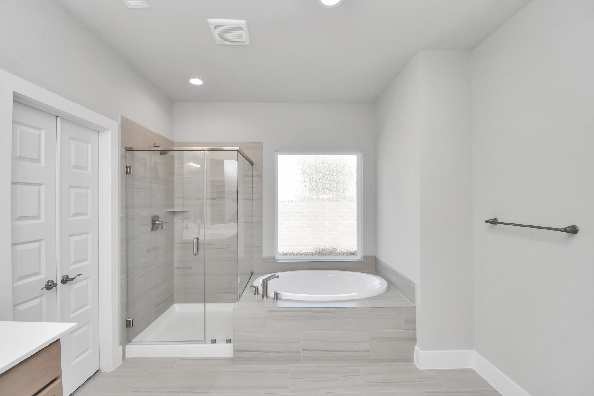 3031 Native Spg Drive Spring, TX 77373 - Photo 21 of 30 Indulge in a spa-like retreat within the confines of this primary bathroom. Delight in a spacious walk-in shower enveloped in stylish tile surround and unwind in a separate garden tub adorned with custom detailing. Sample photo of completed home with similar floor plan. Actual colors and selections may vary.