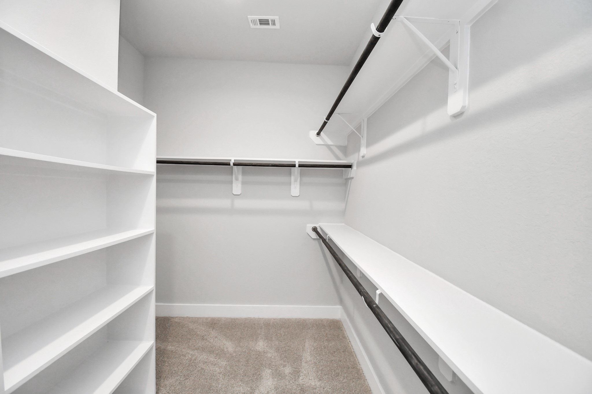 3031 Native Spg Drive Spring, TX 77373 - Photo 23 of 30 Walk-in closet that epitomizes luxury and practicality. This generously sized space features built-in shelving, offering abundant room for impeccable organization. High ceilings and recessed lighting create a bright and welcoming ambiance. Sample photo of completed home with similar floor plan. Actual colors and selections may vary.