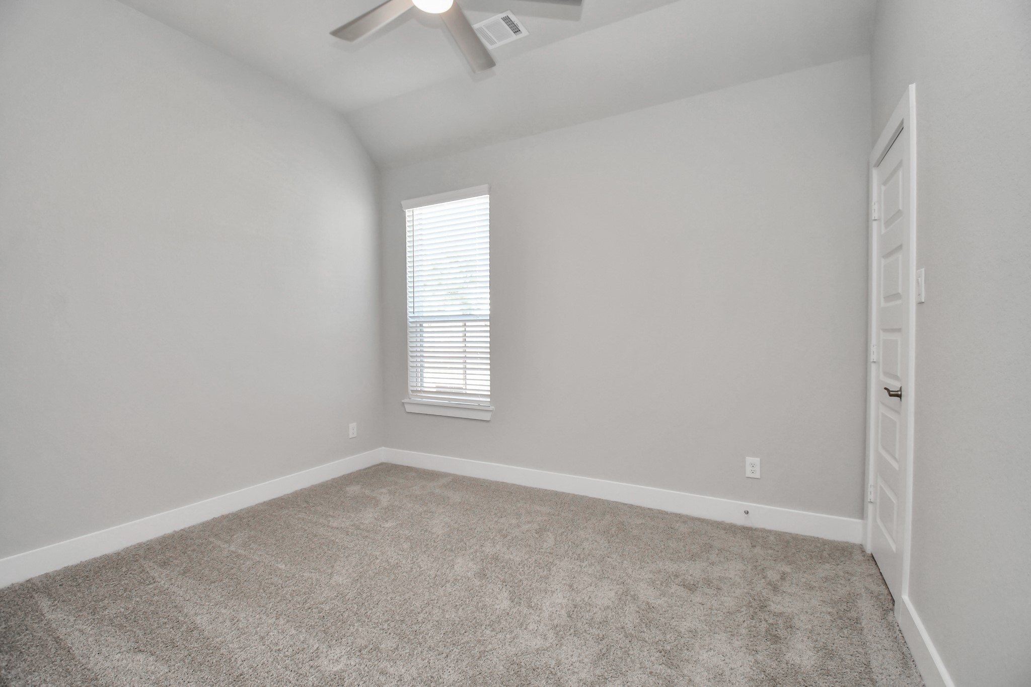 3031 Native Spg Drive Spring, TX 77373 - Photo 25 of 30 Secondary bedroom features plush carpeting, large windows that let in plenty of natural light, bright paint, and spacious closets. Sample photo of completed home with similar floor plan. Actual colors and selections may vary.