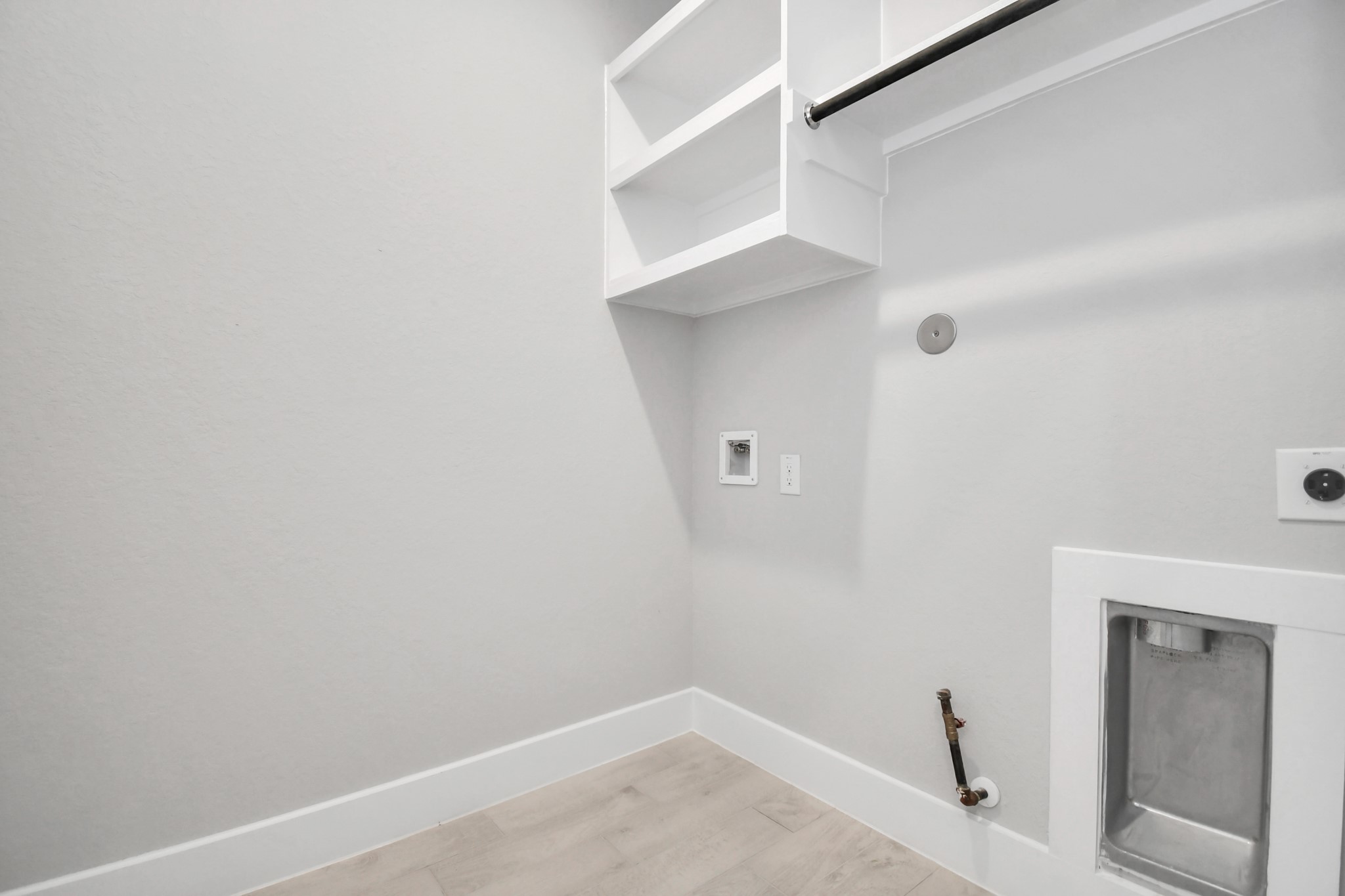 3031 Native Spg Drive Spring, TX 77373 - Photo 29 of 30 A perfect blend of functionality and comfort. Capture the essence of easy living with a first-floor laundry room, thoughtfully equipped with shelving for effortless organization. Both electric and gas connections available. Sample photo of completed home with similar floor plan. Actual colors and selections may vary.